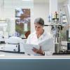 lab researcher reading binder - CREDIT_iStock-1646508449