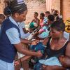 A nurse takes the blood pressures of a woman as she waits with an infant at Ndirande Health Centre in Blantyre on February 21, 2018 - Image credit - Getty-922184246
