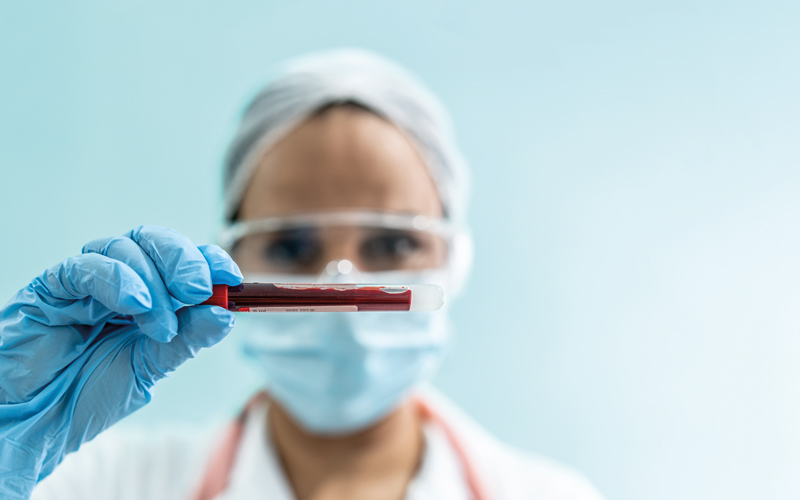 lab holding vial blood - CREDIT - iStock-1266993064