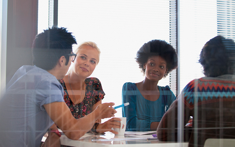 Smiling business people meeting in conference room- CREDIT-istock-157864298